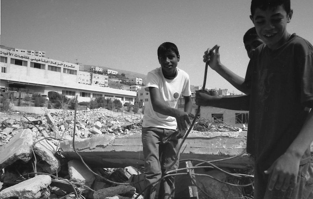 Askar, boys playing in the rubble