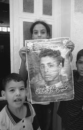 Kids with their brother's martyr poster